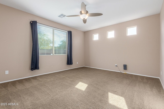 spare room featuring ceiling fan and carpet flooring