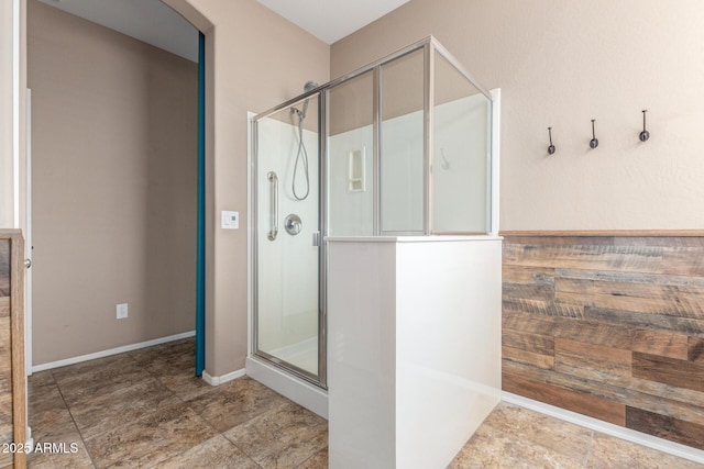 bathroom featuring a shower with door