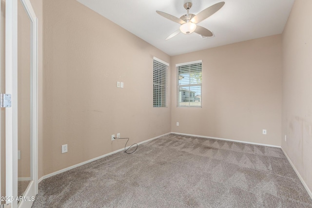 carpeted spare room with ceiling fan