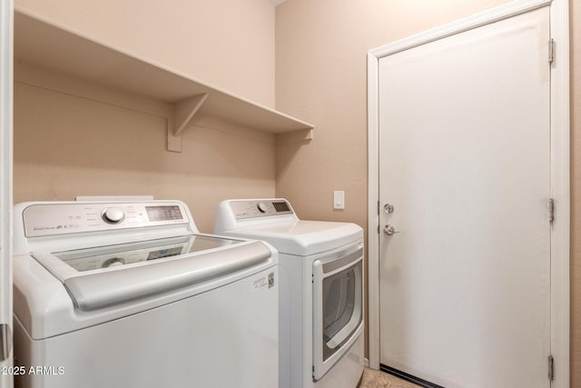 washroom with washing machine and clothes dryer