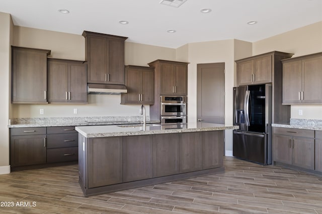 kitchen featuring light hardwood / wood-style flooring, stainless steel appliances, dark brown cabinets, and sink