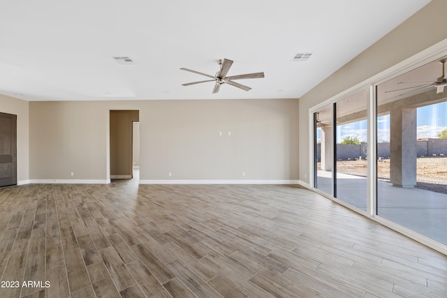 spare room with light wood-type flooring and ceiling fan