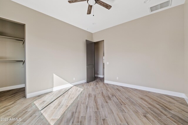 spare room featuring ceiling fan, vaulted ceiling, and light hardwood / wood-style flooring