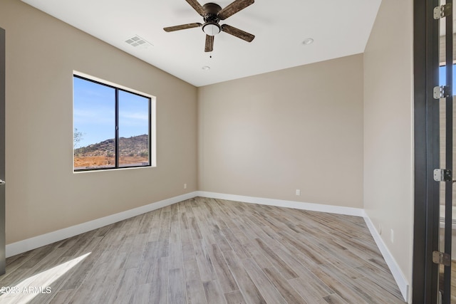 empty room with light hardwood / wood-style flooring and ceiling fan