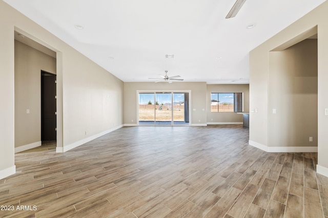 unfurnished living room with light hardwood / wood-style flooring and ceiling fan