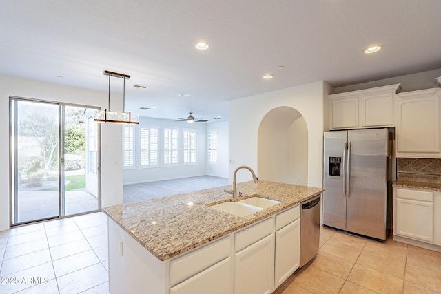 kitchen with pendant lighting, white cabinetry, sink, a kitchen island with sink, and stainless steel appliances