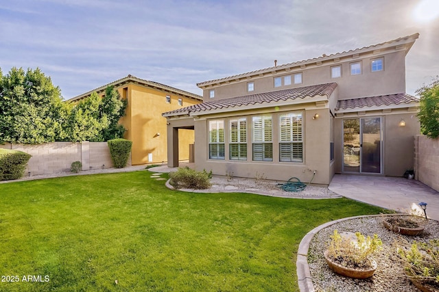 back of property with a yard and a patio area