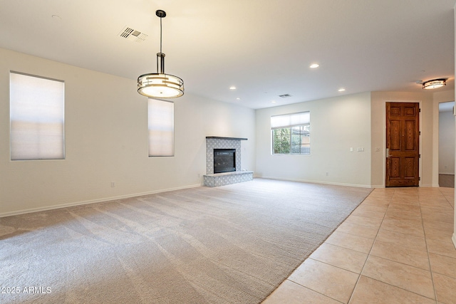 unfurnished living room with light colored carpet