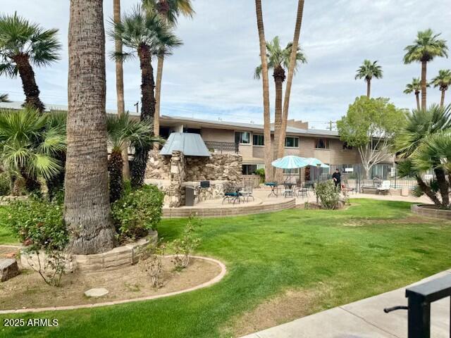 rear view of house featuring a lawn and a patio area