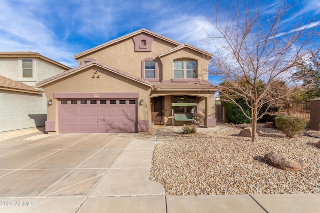 traditional-style house featuring concrete driveway, a tile roof, an attached garage, fence, and stucco siding