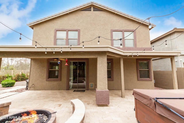22905 N 19th Way, Phoenix, AZ 85024 - back of property featuring a hot tub, stucco siding, a fenced backyard, and an outdoor fire pit