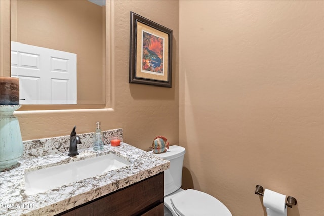 bathroom featuring toilet and vanity