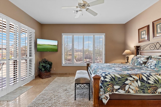 bedroom with ceiling fan and light tile patterned flooring