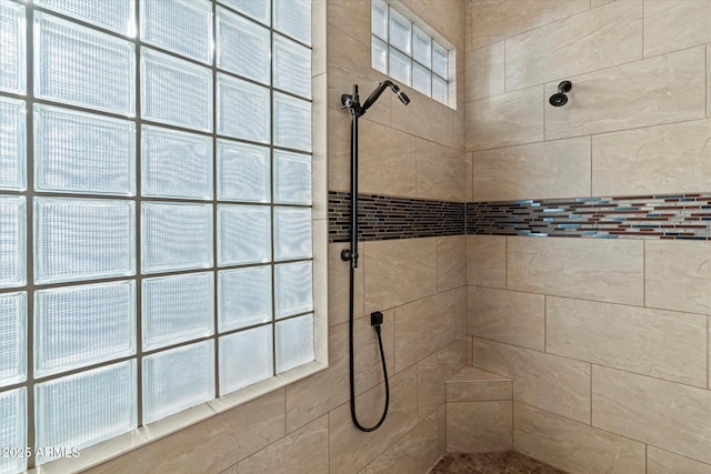 bathroom with tiled shower