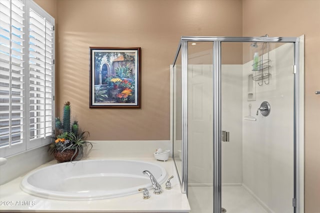 bathroom featuring shower with separate bathtub