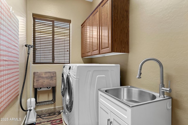 washroom with sink, separate washer and dryer, and cabinets