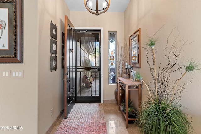 tiled foyer with a notable chandelier