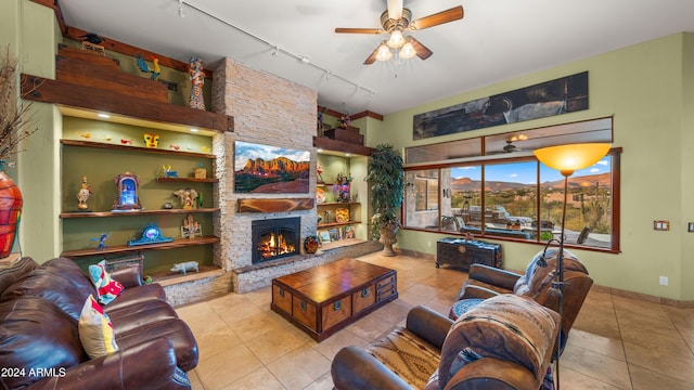 living room featuring ceiling fan, light tile patterned floors, a fireplace, and track lighting