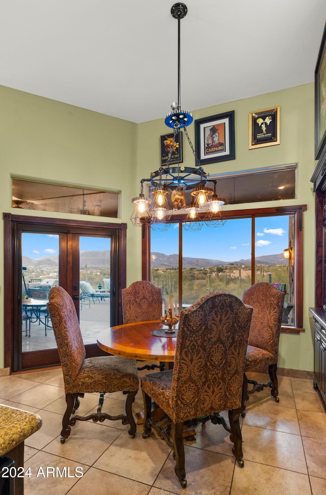 tiled dining room featuring a mountain view and french doors