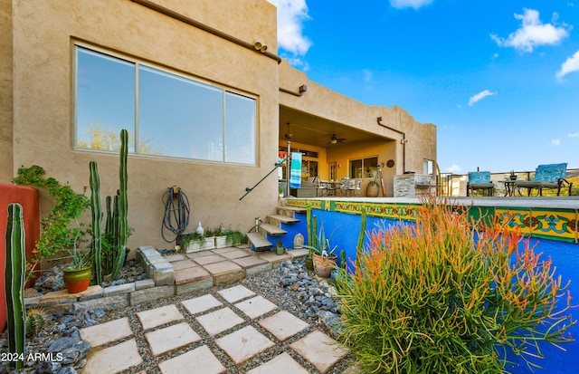 view of pool featuring ceiling fan and a patio