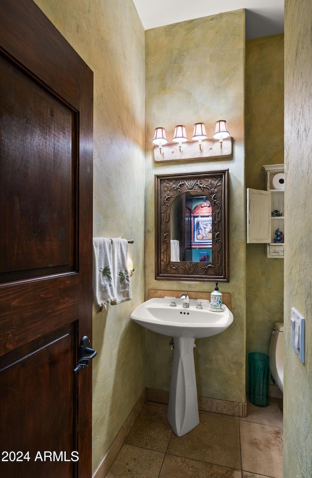 bathroom with tile patterned floors and toilet