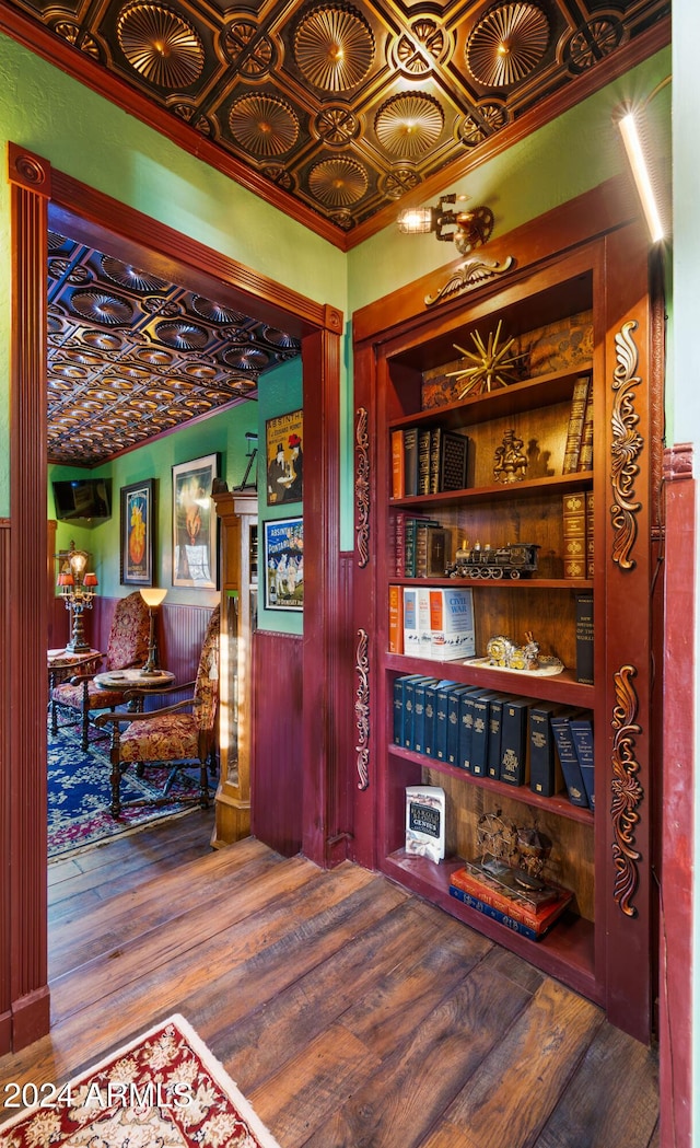 interior space with built in shelves and wood-type flooring