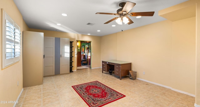 interior space with light tile patterned floors and ceiling fan