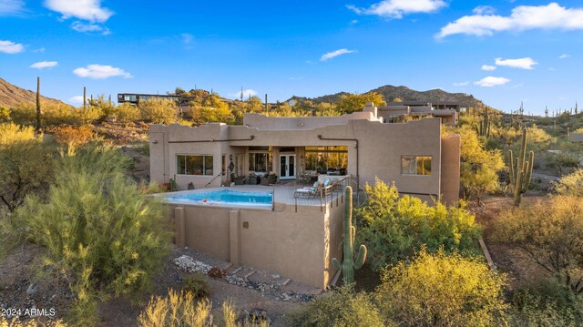 rear view of house featuring a mountain view and a patio