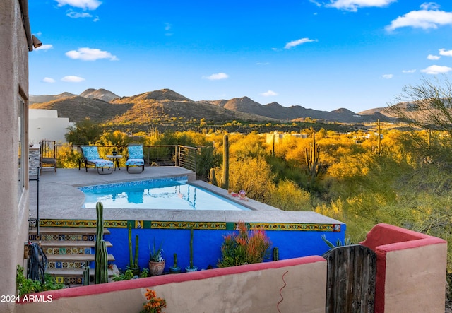 view of pool featuring a mountain view and a patio area