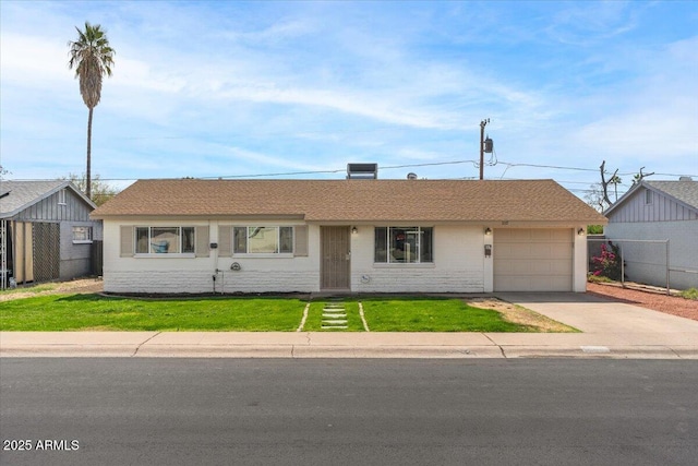 single story home with an attached garage, fence, a front lawn, and concrete driveway