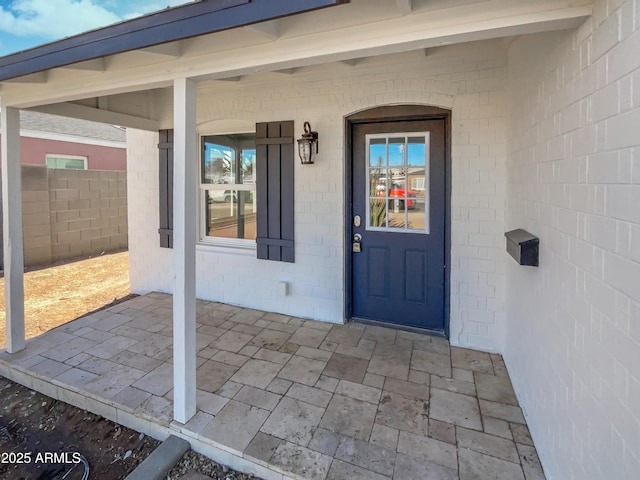 view of exterior entry featuring fence