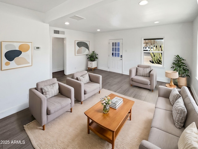 living area with recessed lighting, visible vents, baseboards, and wood finished floors