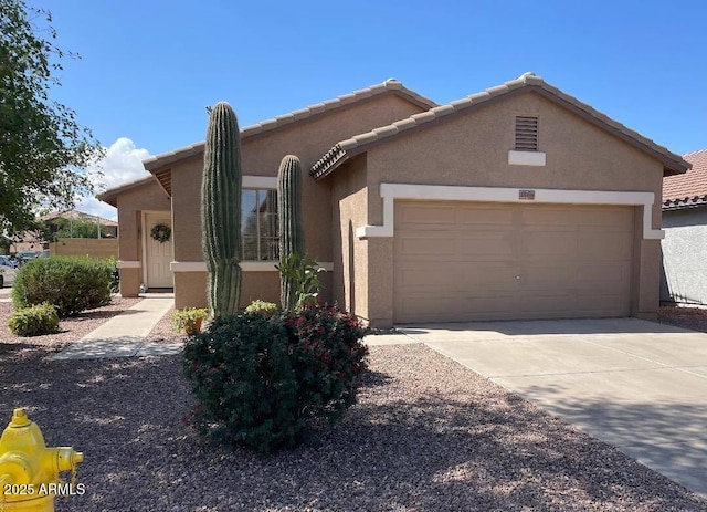 45475 W Guilder Ave, Maricopa, AZ 85139 - view of front of property with stucco siding, a garage, concrete driveway, and a tiled roof