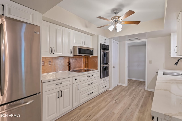 kitchen featuring ceiling fan, sink, white cabinetry, light wood-type flooring, and stainless steel appliances