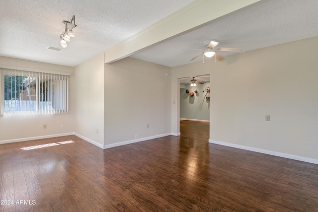 spare room featuring ceiling fan, dark wood-type flooring, and a textured ceiling