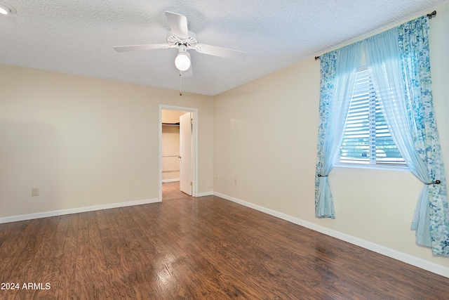 empty room with ceiling fan, a textured ceiling, and hardwood / wood-style flooring