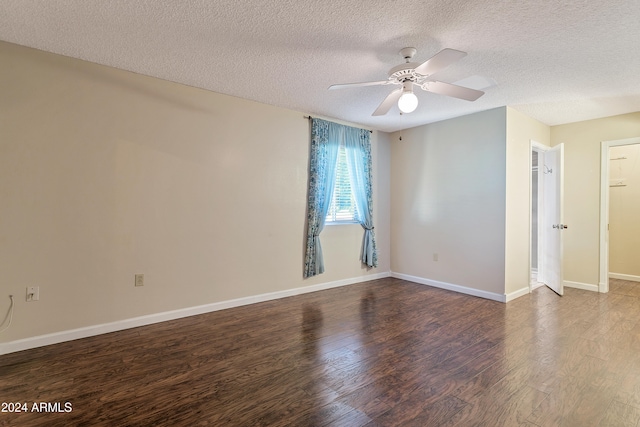 unfurnished room featuring ceiling fan, a textured ceiling, and dark hardwood / wood-style floors