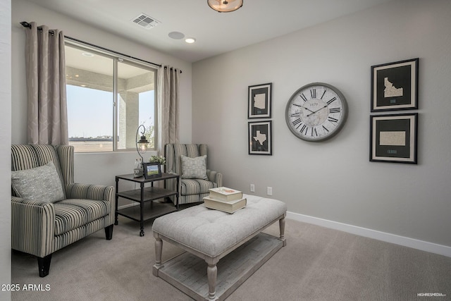 living area with light colored carpet