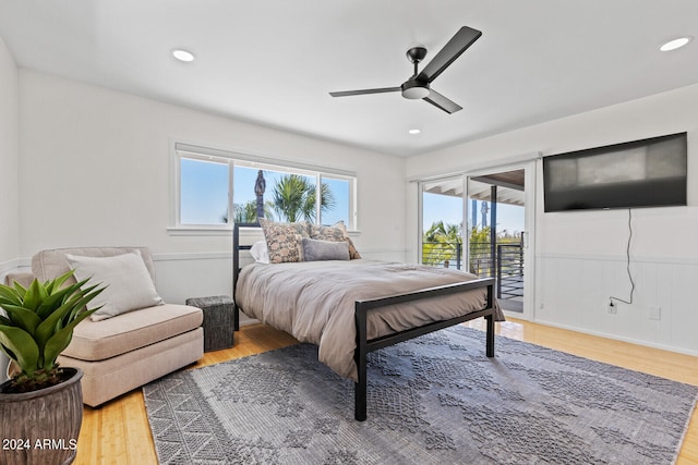 bedroom featuring ceiling fan, hardwood / wood-style flooring, and access to exterior