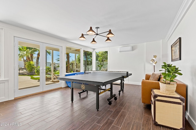 rec room with a wall mounted AC, crown molding, and dark wood-type flooring