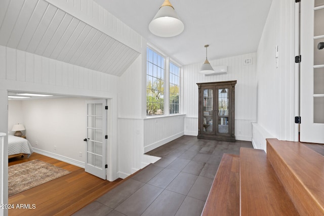 entryway with french doors, dark wood-type flooring, and vaulted ceiling