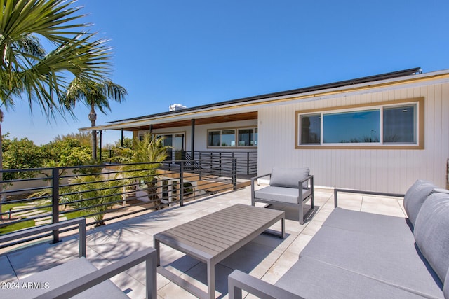 view of patio / terrace with an outdoor living space and a balcony