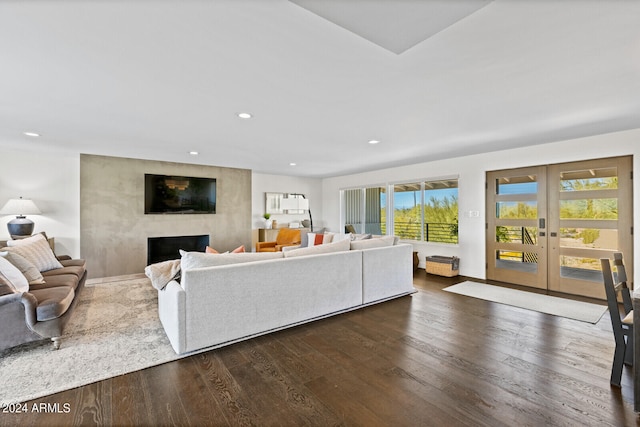 living room featuring french doors, dark hardwood / wood-style floors, and a fireplace