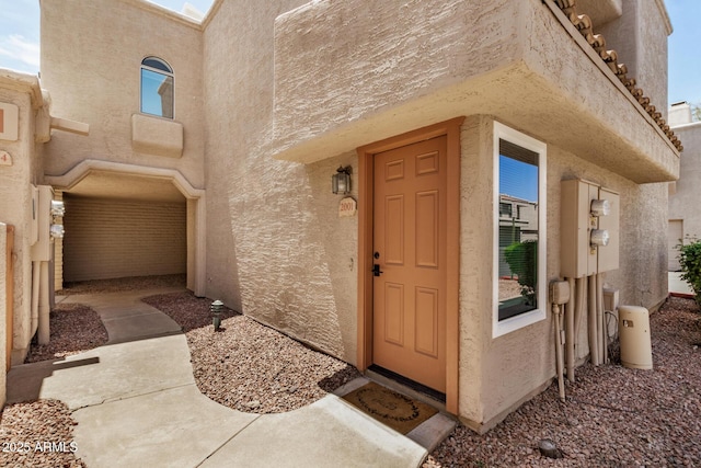 property entrance featuring stucco siding