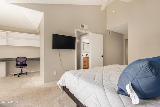 carpeted bedroom featuring visible vents, connected bathroom, baseboards, and high vaulted ceiling