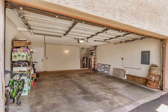 garage featuring electric water heater, a garage door opener, and electric panel