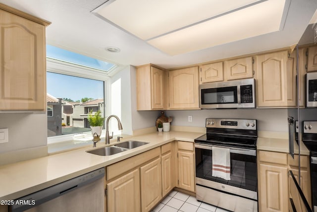 kitchen with light brown cabinetry and stainless steel appliances