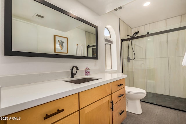 full bathroom with visible vents, a stall shower, toilet, and vanity