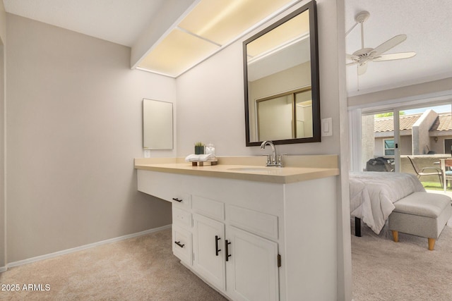 ensuite bathroom featuring baseboards, ceiling fan, vanity, and ensuite bathroom