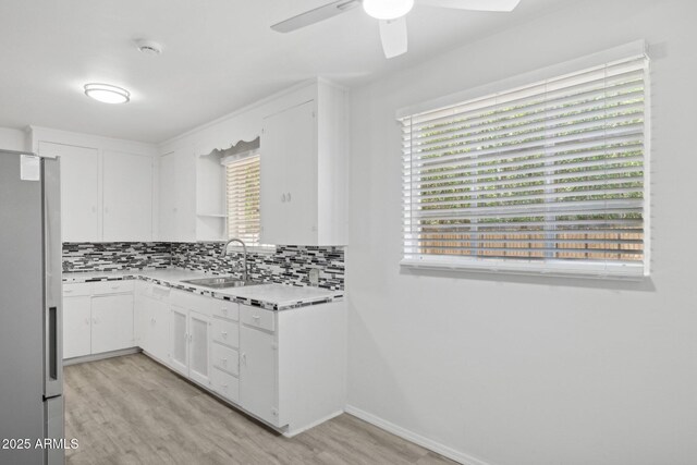 541 W Vernon Ave, Phoenix, AZ 85003 - kitchen featuring stainless steel fridge, light countertops, backsplash, and ceiling fan
